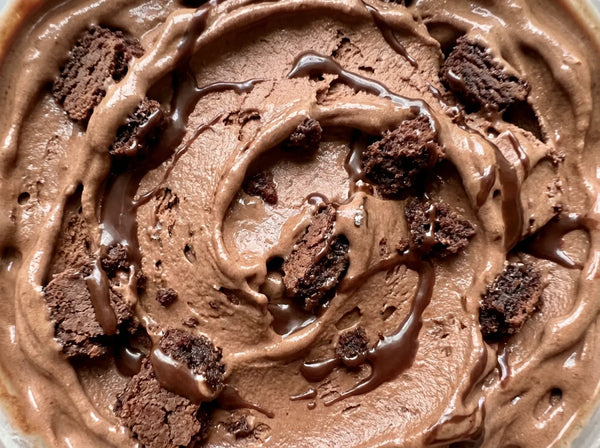 Brownie Fudge Ninja Creami recipe made with CRUSHS chocolate protein ice cream mix, brownie chunks, and chocolate syrup.