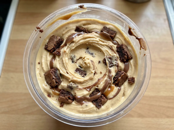 Caramel Brownie Ninja Creami recipe made with CRUSHS salted caramel protein ice cream mix, brownie chunks, and chocolate drizzle.