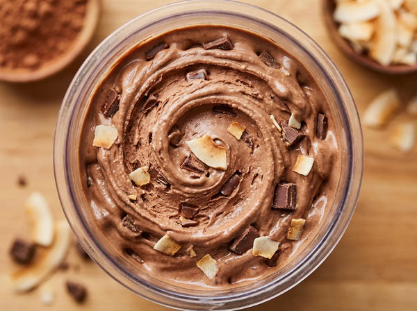 Island Fudge Ninja Creami recipe made with CRUSHS chocolate protein ice cream mix, chocolate chunks, and toasted coconut flakes