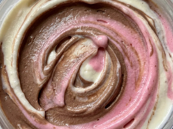 Neapolitan Ninja Creami protein ice cream blending vanilla, chocolate, and strawberry protein base together in one pint.