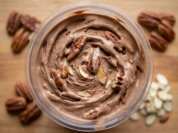 Praline Pecan Crunch Ninja Creami protein ice cream with praline pecans and sliced almonds folded into a chocolate base.