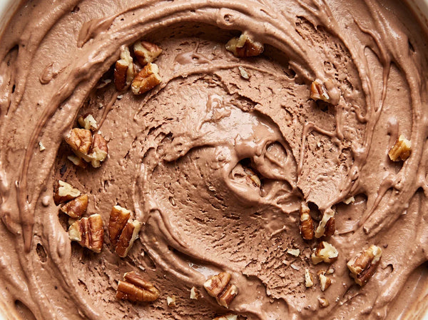 Turtle Tracks Ninja Creami recipe made with CRUSHS salted caramel protein ice cream mix, chopped pecans, and chocolate drizzle.