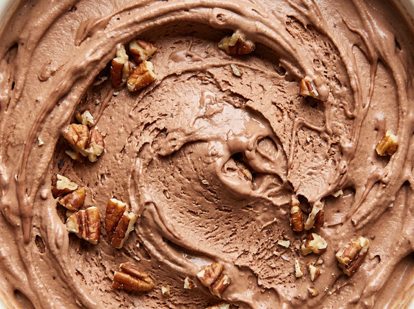 Turtle Tracks Ninja Creami recipe made with CRUSHS salted caramel protein ice cream mix, chopped pecans, and chocolate drizzle.