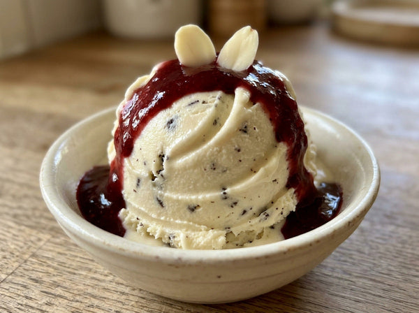 Vampire Bite Ninja Creami recipe made with CRUSHS vanilla protein ice cream mix, dark chocolate chips, raspberry sauce, and sliced almond fangs.