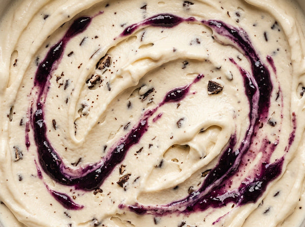 Witch's Brew Ninja Creami recipe made with CRUSHS vanilla protein ice cream mix, mini dark chocolate chips, and a blackberry jam swirl.