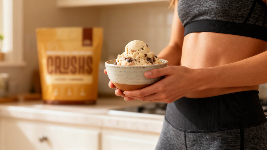 A fit person's torso and arms in gym clothes eating a bowl of protein ice cream in a kitchen showing how post workout nutrition answers the question of why am i not seeing results from working out.
