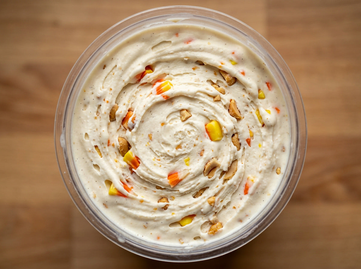 Candy Corn Crunch Ninja Creami recipe made with CRUSHS vanilla protein ice cream mix, chopped candy corn, and honey roasted peanuts.