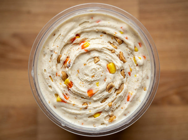 Candy Corn Crunch Ninja Creami recipe made with CRUSHS vanilla protein ice cream mix, chopped candy corn, and honey roasted peanuts.