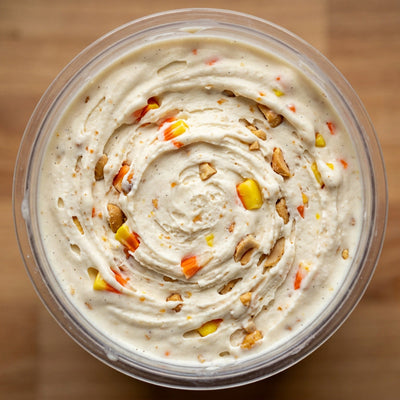 Candy Corn Crunch Ninja Creami recipe made with CRUSHS vanilla protein ice cream mix, chopped candy corn, and honey roasted peanuts.