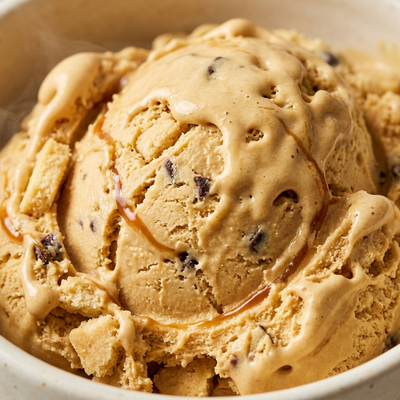 Caramel Cookie Bar Ninja Creami recipe made with CRUSHS salted caramel protein ice cream mix, shortbread pieces, chocolate chips, and caramel sauce.