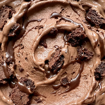 Brownie Fudge Ninja Creami recipe made with CRUSHS chocolate protein ice cream mix, brownie chunks, and chocolate syrup.