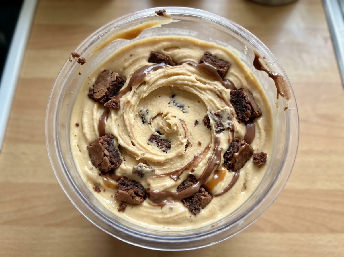 Caramel Brownie Ninja Creami recipe made with CRUSHS salted caramel protein ice cream mix, brownie chunks, and chocolate drizzle.