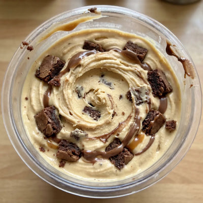 Caramel Brownie Ninja Creami recipe made with CRUSHS salted caramel protein ice cream mix, brownie chunks, and chocolate drizzle.