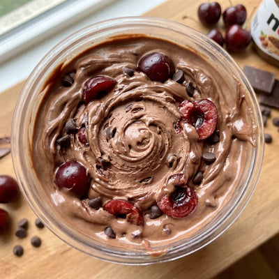 Chocolate Cherry Truffle Ninja Creami protein ice cream with cherries, Nutella swirl, and mini chocolate chips folded into a chocolate base.
