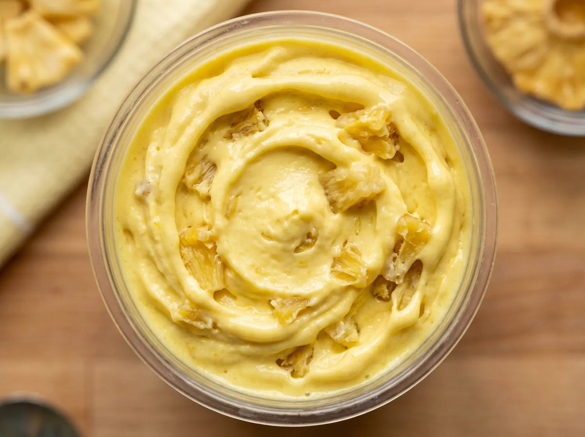Dole Whip Ninja Creami protein ice cream with pineapple chunks folded into a creamy vanilla base.