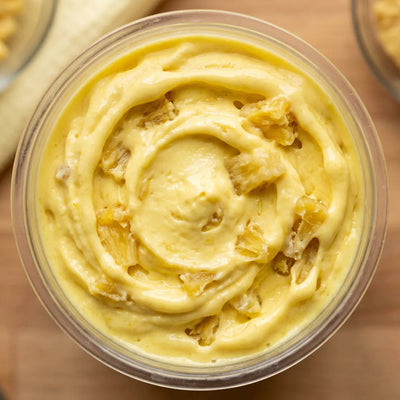 Dole Whip Ninja Creami protein ice cream with pineapple chunks folded into a creamy vanilla base.