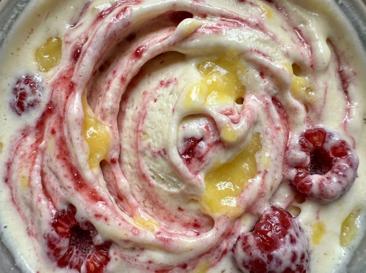 Lemonberry Lift Ninja Creami recipe made with CRUSHS vanilla protein ice cream mix, raspberries, and lemon curd.