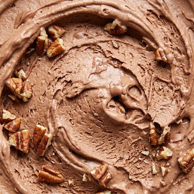 Turtle Tracks Ninja Creami recipe made with CRUSHS salted caramel protein ice cream mix, chopped pecans, and chocolate drizzle.