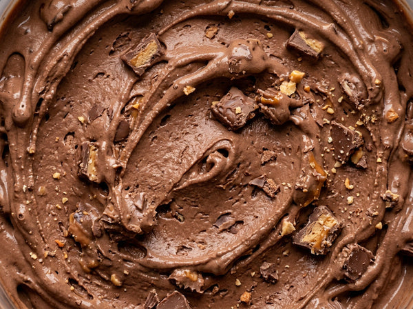 Leftover Halloween Candy Ninja Creami recipe made with CRUSHS chocolate protein ice cream mix, chopped candy bars, and mini peanut butter cups.