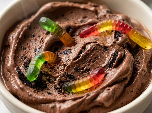 Graveyard Dirt Cup Ninja Creami recipe made with CRUSHS chocolate protein ice cream mix, crushed chocolate sandwich cookies, and gummy worms.