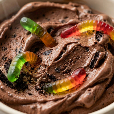 Graveyard Dirt Cup Ninja Creami recipe made with CRUSHS chocolate protein ice cream mix, crushed chocolate sandwich cookies, and gummy worms.