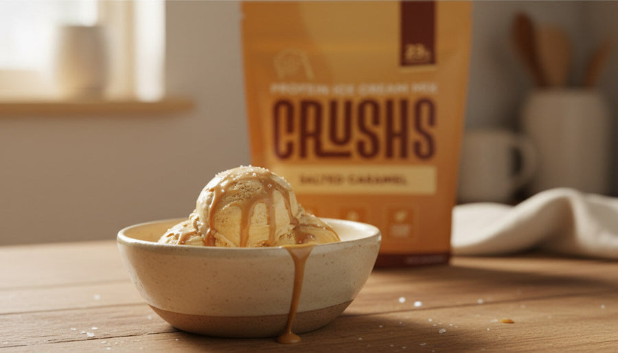 A creamy scoop of salted caramel ice cream in a bowl with a CRUSHS Protein Ice Cream Mix bag visible behind it representing the easiest high protein dessert ideas for Ninja Creami owners.