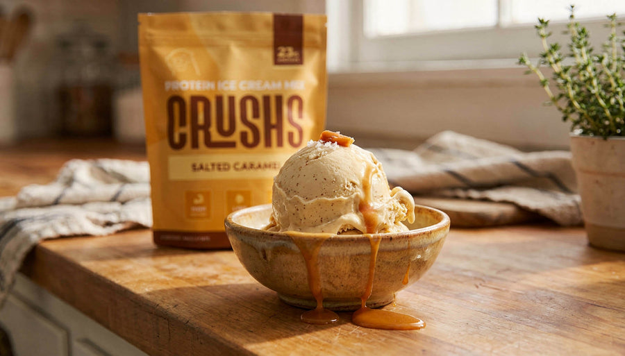 A creamy scoop of salted caramel protein ice cream in a ceramic bowl with a CRUSHS Salted Caramel Protein Ice Cream Mix bag visible behind it representing the answer to is protein ice cream healthy when the ingredients are right.