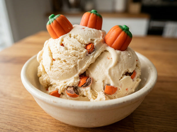 Jack-o'-Lantern Ninja Creami recipe made with CRUSHS vanilla protein ice cream mix, orange candy-coated chocolates, and candy pumpkins.