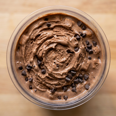 Overhead view of a Ninja Creami pint filled with mocha protein ice cream and chocolate chips recipe.