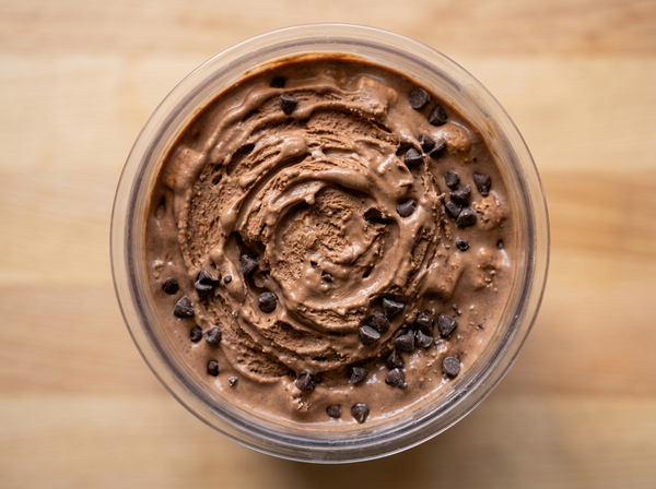 Overhead view of a Ninja Creami pint filled with mocha protein ice cream and chocolate chips recipe.