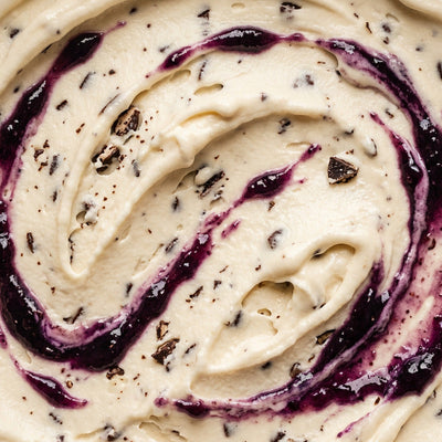 Witch's Brew Ninja Creami recipe made with CRUSHS vanilla protein ice cream mix, mini dark chocolate chips, and a blackberry jam swirl.