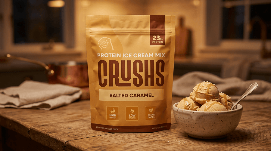 CRUSHS protein ice cream mix bag next to a bowl of freshly scooped creamy ice cream on a wooden surface, representing CRUSHS as the best protein ice cream mix for Ninja Creami batch prep