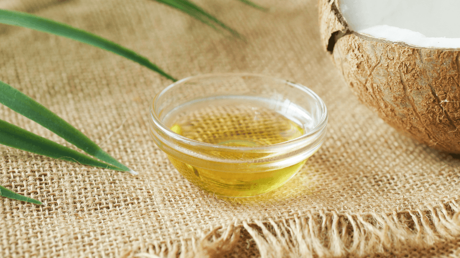 A small glass bowl of coconut oil on burlap as a healthy MCT oil alternative to add to coffee for sustained energy.