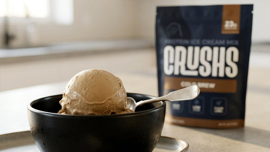 A creamy scoop of cold brew protein ice cream in a sleek black bowl with a CRUSHS Cold Brew Protein Ice Cream Mix bag visible behind it showing the best side of the protein ice cream vs regular ice cream comparison.