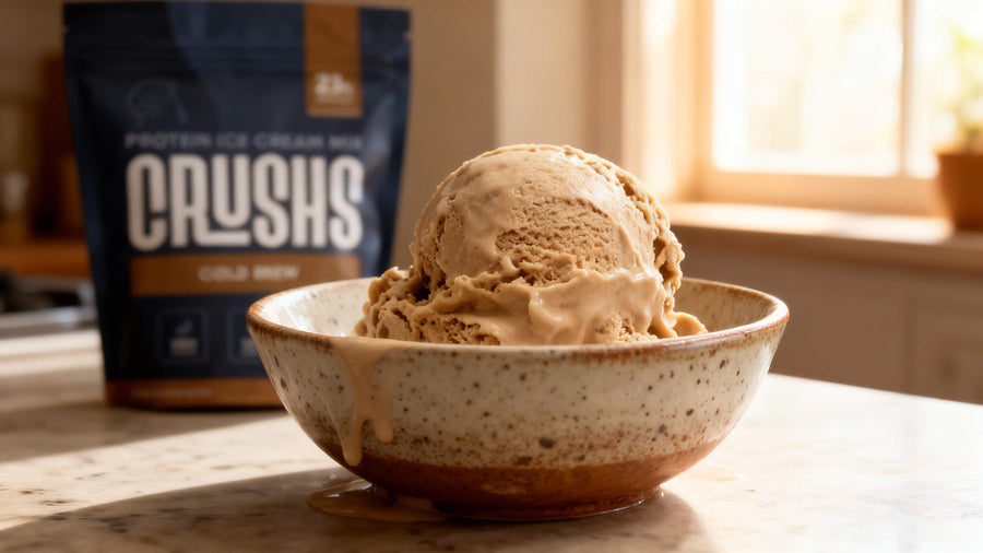 A bowl of protein ice cream with a CRUSHS Cold Brew Protein Ice Cream Mix bag visible beside it showing real post workout recovery nutrition.
