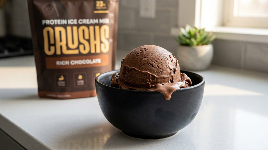 A creamy scoop of rich chocolate protein ice cream in a sleek black bowl with a CRUSHS Rich Chocolate Protein Ice Cream Mix bag visible behind it showing the result of using the right protein source when deciding what protein powder to use Ninja Creami.
