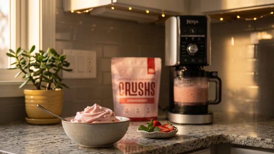 A CRUSHS protein ice cream bag next to a Ninja Creami machine with a fresh bowl of pink ice cream as the perfect way to end how to celebrate Mother's Day.