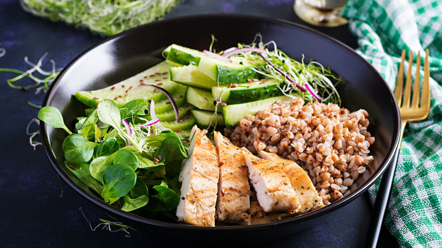 A bowl of grilled chicken with greens and grains showing the kind of high protein meal that supports fat loss better than relying on cardio alone to cancel out what you eat.