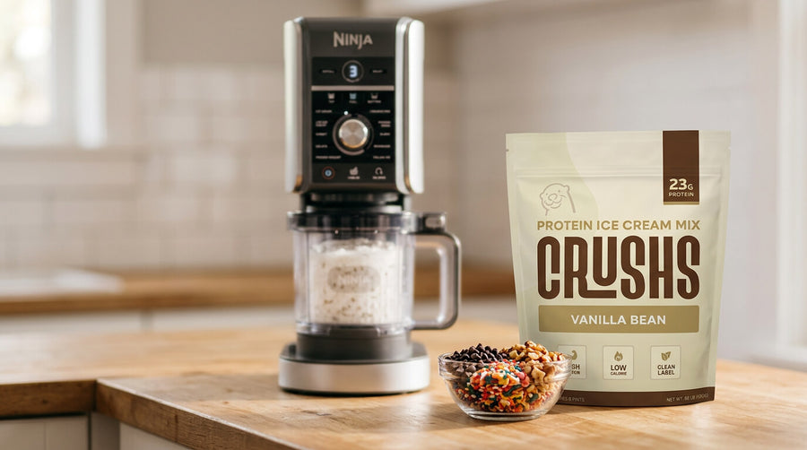 Ninja Creami machine next to a CRUSHS protein ice cream bag and chocolate toppings as a Mother's Day gift for health conscious moms.