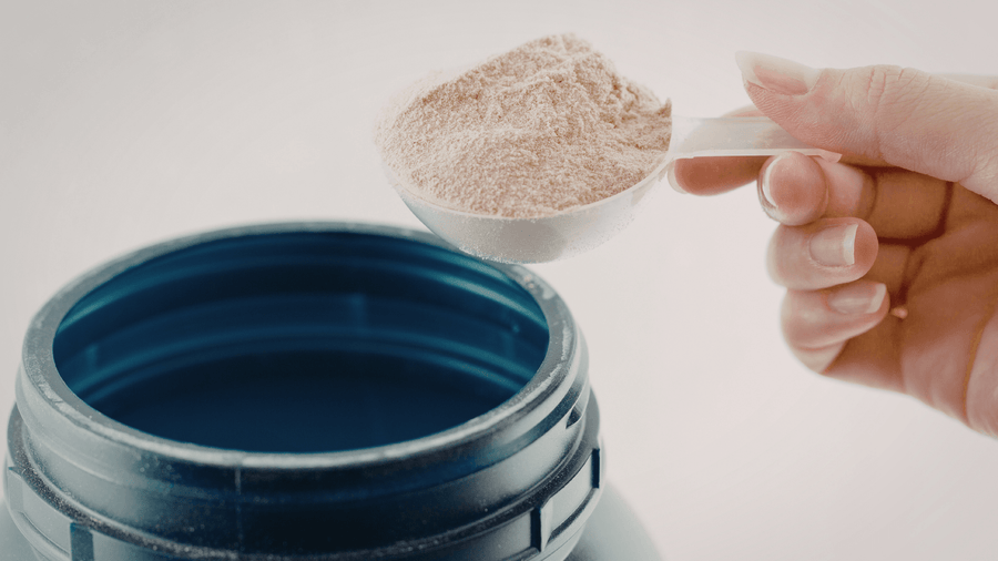 A container of protein powder as a blendable high protein coffee idea for adding 20 to 25 grams of protein to your morning cup.