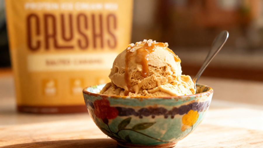 A bowl of CRUSHS creamy salted caramel protein ice cream muscle growth style on a kitchen counter, warm natural light, representing a high protein dessert that supports post workout recovery.